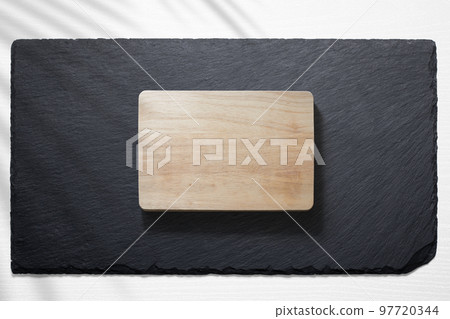 Cutting board against a slate plate Cutting board against a slate plate 97720344