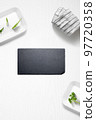 Flat lay of a kitchen with a slate plate and herbs 97720358