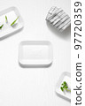 Flat lay of a kitchen with styrofoam containers and herbs 97720359