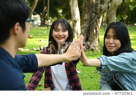 University students are giving high five, celebrating together. University, youth lifestyle and friendship concept University students are giving high five, celebrating together. University, youth lifestyle and friendship concept 97720361