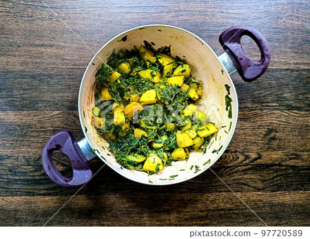Aloo Palak sabzi - Potato cooked with spinach with added spices. a healthy Indian main course recipe 97720589
