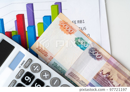 Financial chart with Russian rubles money stack with calculator. Currency appreciation concept Financial chart with Russian rubles money stack with calculator. Currency appreciation concept 97721197