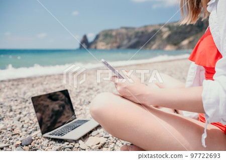 Woman sea laptop. Business woman working on laptop by sea at sunset. Close up on hands of pretty lady typing on computer outdoors summer day. Freelance, digital nomad, travel and holidays concept. 97722693
