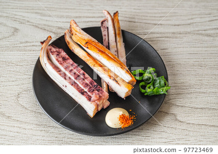 Overnight dried squid on a black plate 97723469