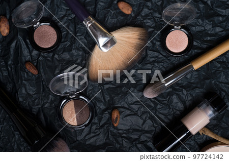 set of cosmetics and nature chocolate on black background set of cosmetics and nature chocolate on black background 97724142