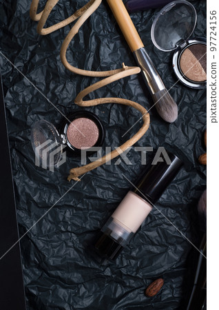 set of cosmetics and nature chocolate on black background set of cosmetics and nature chocolate on black background 97724156