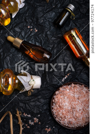 set of nature precious oils and  cosmetics on black background . 97724174