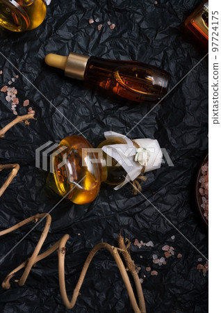 set of nature precious oils and  cosmetics on black background . 97724175