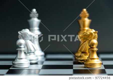 Gold pawn, horse knight and king in chess game face with the another silver team on black background (Concept for company strategy, business victory or decision) Gold pawn, horse knight and king in chess game face with the another silver team on black background (Concept for company strategy, business victory or decision) 97724456