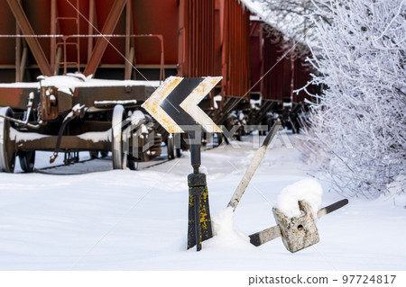 Railroad switch with train in the winter Railroad switch with train in the winter 97724817