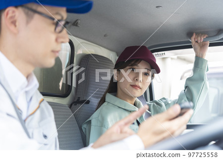 Male truck driver checking smartphone before departure 97725558
