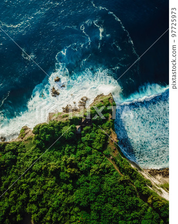 Aerial view of cape with forest and ocean with waves in tropical island 97725973