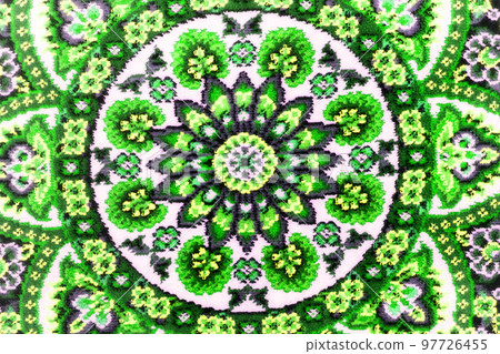 Part of rough woven carpet close-up. Green abstract patterns. Symmetrical background.. Part of rough woven carpet close-up. Green abstract patterns. Symmetrical background.. 97726455