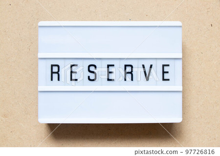 Lightbox with word reserve on wood background 97726816