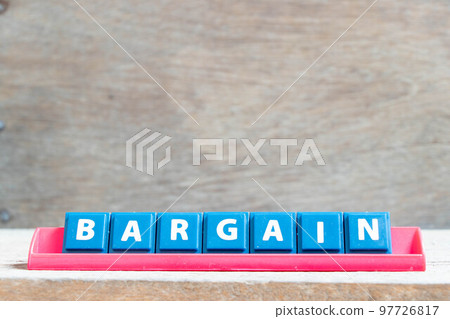 Tile alphabet letter with word bargain in red color rack on wood background Tile alphabet letter with word bargain in red color rack on wood background 97726817
