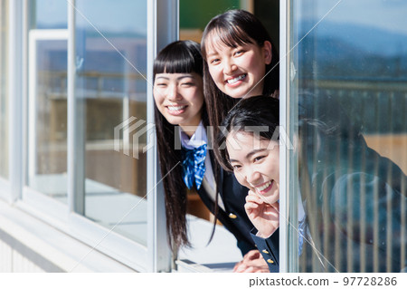 High school girl looking into the classroom through the window 97728286
