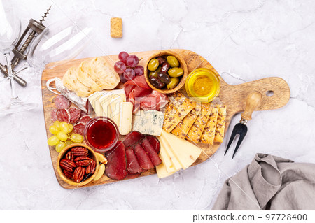 Antipasto board with prosciutto, salami, crackers, cheese Antipasto board with prosciutto, salami, crackers, cheese 97728400