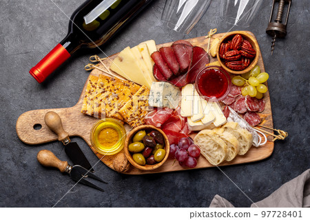 Antipasto board with prosciutto, salami, crackers, cheese Antipasto board with prosciutto, salami, crackers, cheese 97728401