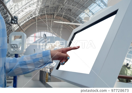 Woman hand touching interactive white touchscreen display kiosk: close up Woman hand touching interactive white touchscreen display kiosk: close up 97728673