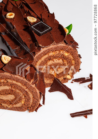 Sliced Swiss roll with buttercream, chocolate shavings and hazelnuts Sliced Swiss roll with buttercream, chocolate shavings and hazelnuts 97728868