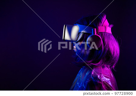 Woman in virtual reality goggle in neon colors. Woman in virtual reality goggle in neon colors. 97728900