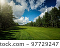 Panorama view of a Golf Course with fairway field. Golf course with a rich green turf beautiful scenery.  97729247