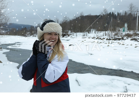 Woman in hat with ear flaps outdoor 97729437