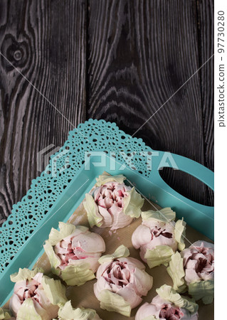 Zephyr tulips. Natural homemade marshmallow. Arranged on a tray. Close-up. 97730280