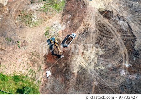 trucks working at the construction site trucks working at the construction site 97732427