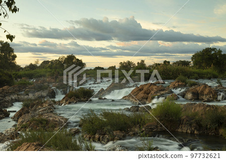 Sunset over Li Phi or Tat Somphamit waterfalls, Laos 97732621