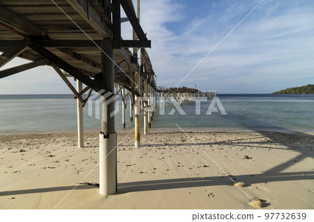 Old wooden boardwalk over the sea, Pulau We Island, Indonesia 97732639