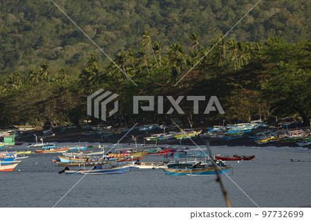Colorful fishing boats moored, Batu Putih Beach, Indonesia 97732699