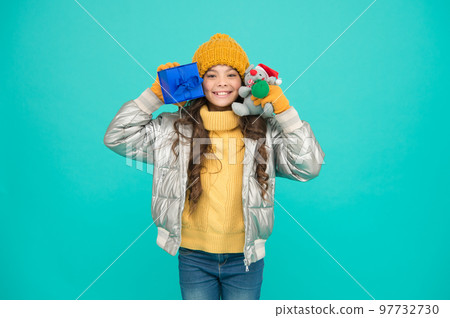happy small girl present. shopping on xmas season. merry christmas. happy new year. Feeling grateful for good gift. fashion kid in trendy puffer jacket. warm winter clothes. online purchase bonus happy small girl present. shopping on xmas season. merry christmas. happy new year. Feeling grateful for good gift. fashion kid in trendy puffer jacket. warm winter clothes. online purchase bonus 97732730