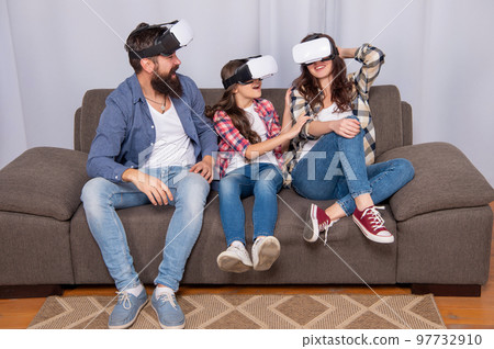 positive mother father and daughter in virtual reality glasses, video game 97732910
