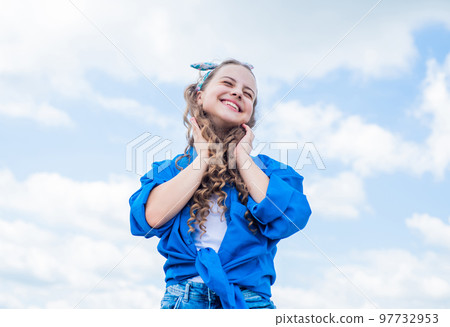 happy childrens day. happy childhood. smiling child with curly hairstyle. hair beauty and care. kid fashion style. teenage girl on sky background outdoor. hipster kid. Facial care 97732953