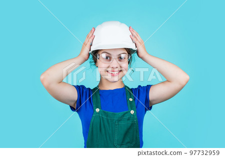 Visiting Construction Site. childhood and education concept. baby building. cute kid putting on construction helmet. childhood happiness concept. Little happy girl engineer 97732959