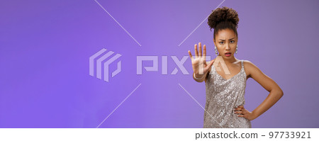 Stop right there. Worried insecure concerned african american woman begging enough extend raised palm enough taboo gesture hold hand waist frowning demanding prohibit, blue background 97733921