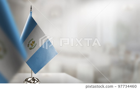Small flags of the Guatemala on an abstract blurry background 97734460