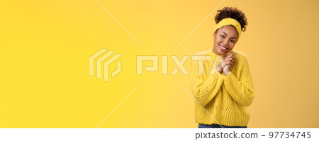Touched tender african-american woman press palms together sighing happily smiling enjoying lovely scene grinning look passionate delighted grateful have united supportive family, yellow background 97734745