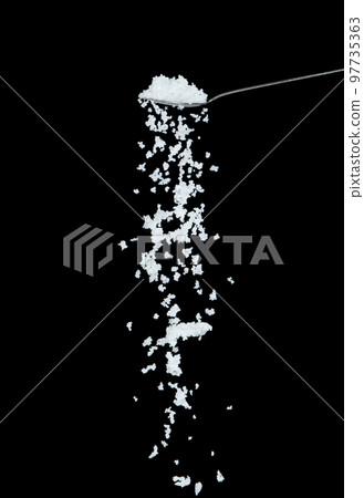 Salt fall, crystal white grain peanuts explode abstract cloud fly from silver spoon. Beautiful complete seed salt, food object design. Selective focus freeze shot black background isolated 97735363