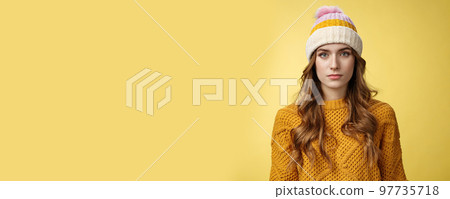 Close-up worried upset attractive young 20s woman look serious nervous sympathizing you listening terrible upsetting story standing yellow background looking camera, wearing hat sweater Close-up worried upset attractive young 20s woman look serious nervous sympathizing you listening terrible upsetting story standing yellow background looking camera, wearing hat sweater 97735718