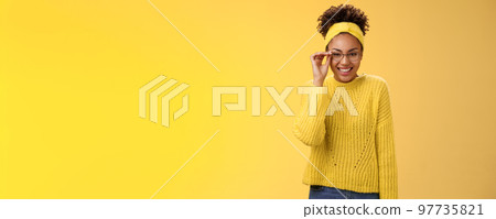 Cute clever best student college girl african-american touch glasses nose smiling broadly work part-time tutor children english lessons smiling friendly standing yellow background sweater, headband 97735821