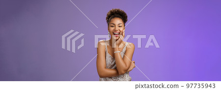 Charming joyful glamour african-american woman in glittering dress touch palm laughing happily attend elegant party chatting enjoying fun event chuckling rejoicing good mood, blue background 97735943