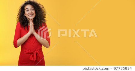Girl with angel smile making eyes as wanting friend make favour, holding hands in pray, grinning and gazing with anticipation as begging for help standing silly and cute against yellow background Girl with angel smile making eyes as wanting friend make favour, holding hands in pray, grinning and gazing with anticipation as begging for help standing silly and cute against yellow background 97735954