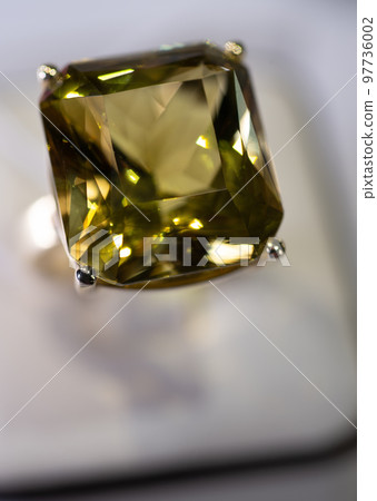 jewelry retail store showcase displaying white gold rings with big citrine gemstone. macro shot 97736002