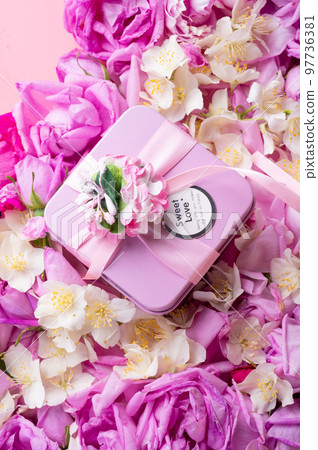 box with gift around roses and jasmine background. romantic and beauty concept. top view box with gift around roses and jasmine background. romantic and beauty concept. top view 97736381