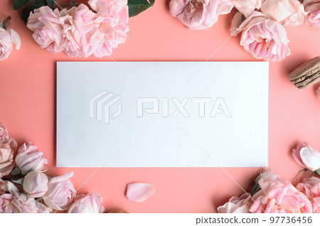 pink roses with white envelope and macaroons around pink background. life style concept 97736456