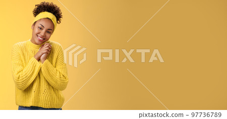 Touched tender african-american woman press palms together sighing happily smiling enjoying lovely scene grinning look passionate delighted grateful have united supportive family, yellow background Touched tender african-american woman press palms together sighing happily smiling enjoying lovely scene grinning look passionate delighted grateful have united supportive family, yellow background 97736789