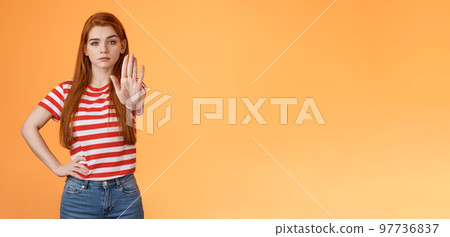 Serious-looking confident brave redhead girl oppose haters, fighting for freedom, prohibit illegal actions, extend hand stop enough, never or forbidden gesture, look determined camera Serious-looking confident brave redhead girl oppose haters, fighting for freedom, prohibit illegal actions, extend hand stop enough, never or forbidden gesture, look determined camera 97736837