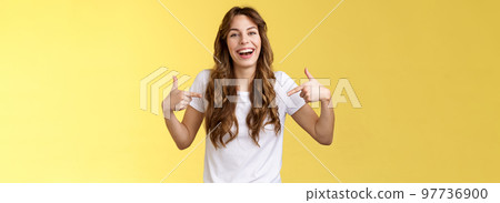 Haha awesome. Positive sincere attractive young woman curly long hair laughing joyfully pointing fingers center copy space white t-shirt chuckling having fun discuss great link show you promo 97736900
